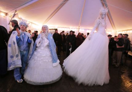 Lowell WinterFest 2018 opening night. WinterFest king and queen, Alexander Holden of Watertown and Kimberly Waller of East Bridgewater, from Big Smile Entertainment, left, and Sasha Gaulin of Worcester, with Fire Gypsy Production, dance at JFK Plaza tent. (SUN/Julia Malakie)